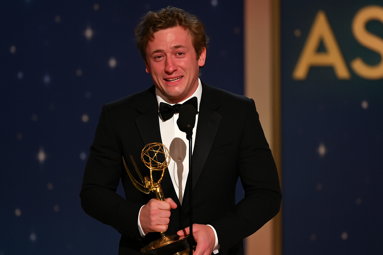 Jeremy Allen White holding his Emmy Award during his acceptance speech, showing his emotional reaction to winning - jeremy allen white