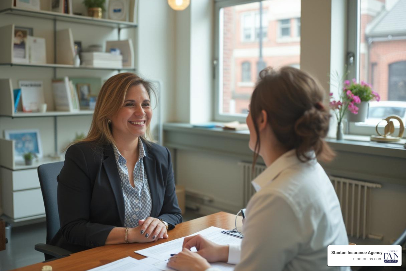 Friendly insurance agent helping client in Massachusetts office - Insurance Agencies Massachusetts