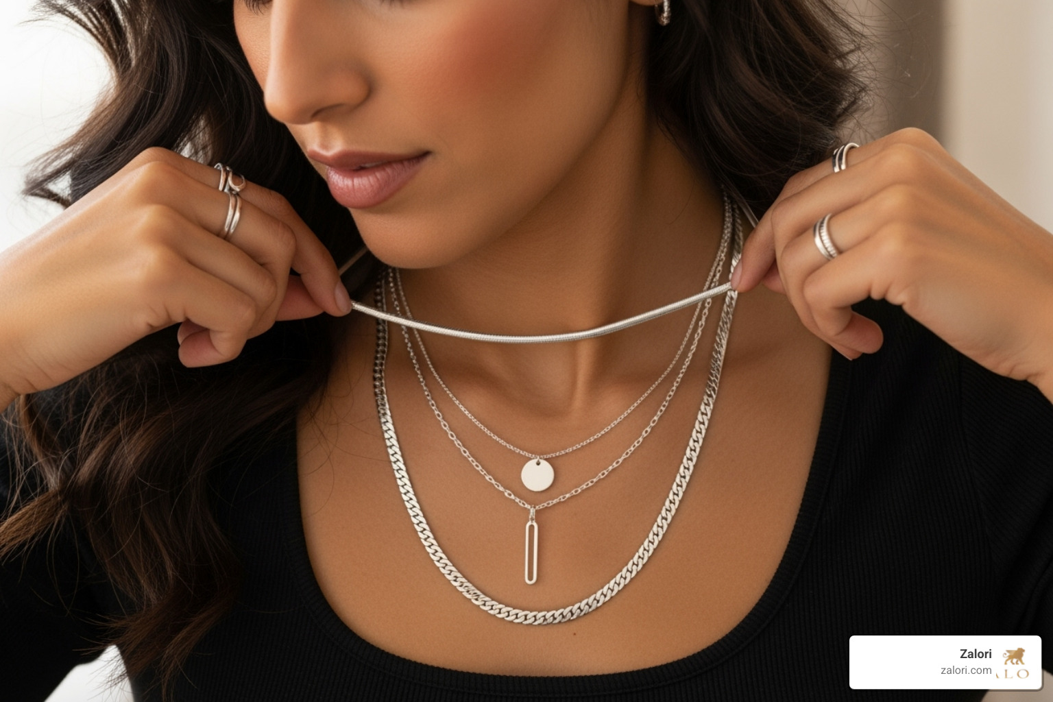 woman layering multiple silver chains of different lengths and styles - pure silver chain