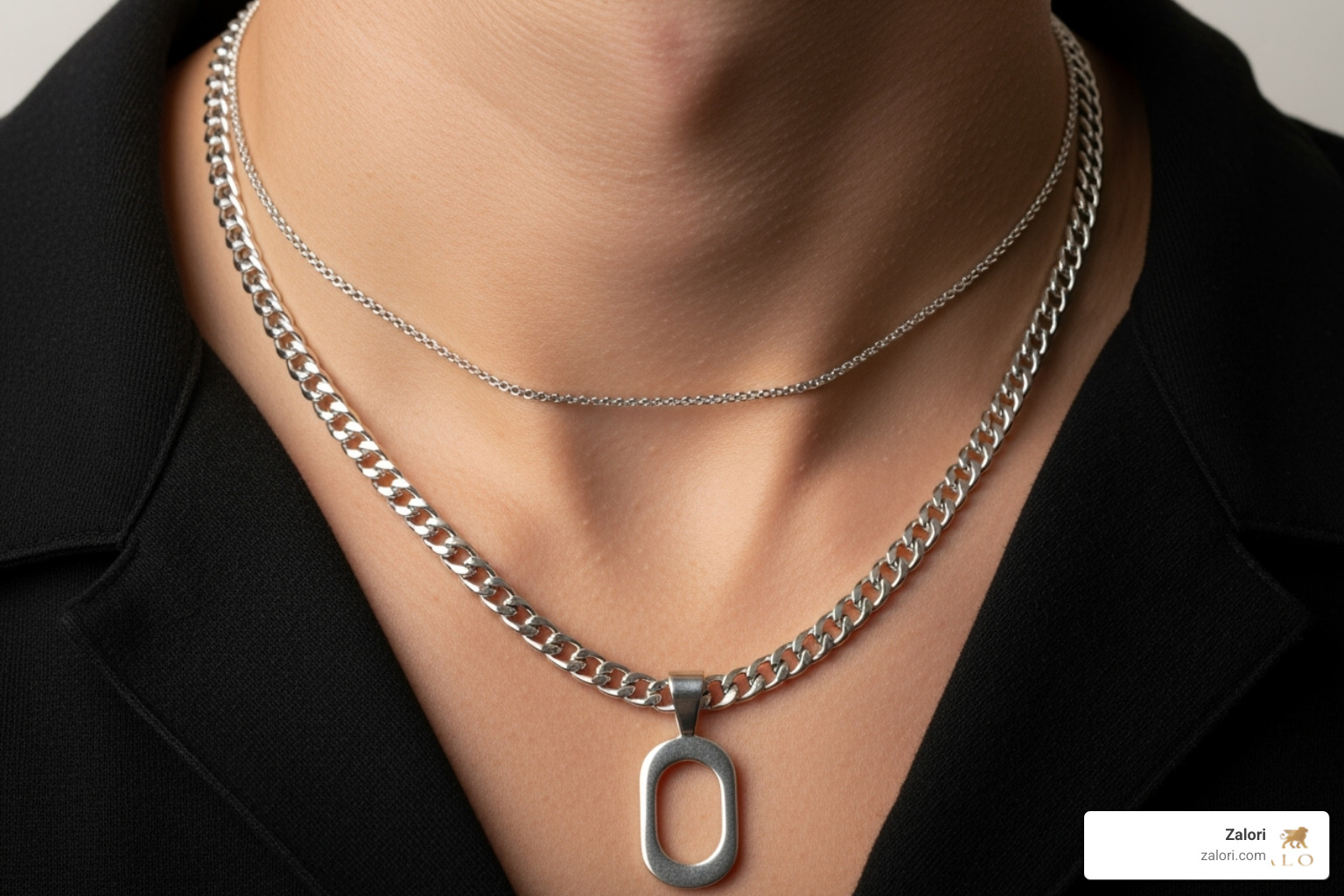 Man layering a thin silver chain with a thicker one featuring a pendant - buy mens silver chain