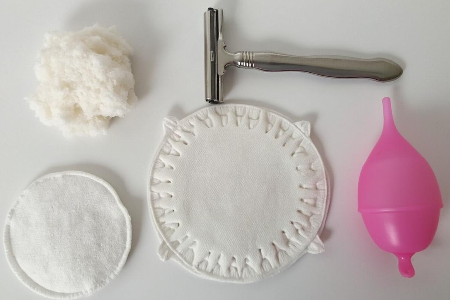 Reusable cotton pads, a safety razor, and a menstrual cup. - Environmentally friendly beauty tips