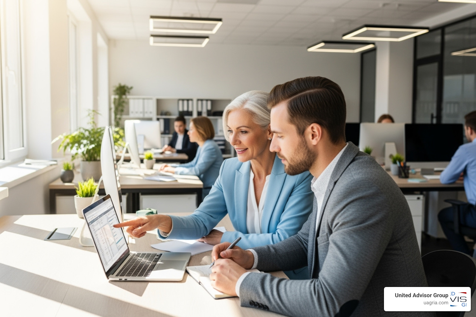 Image of a mentorship session between a senior and junior advisor in a bright, open office - recruiting the next generation of financial advisors