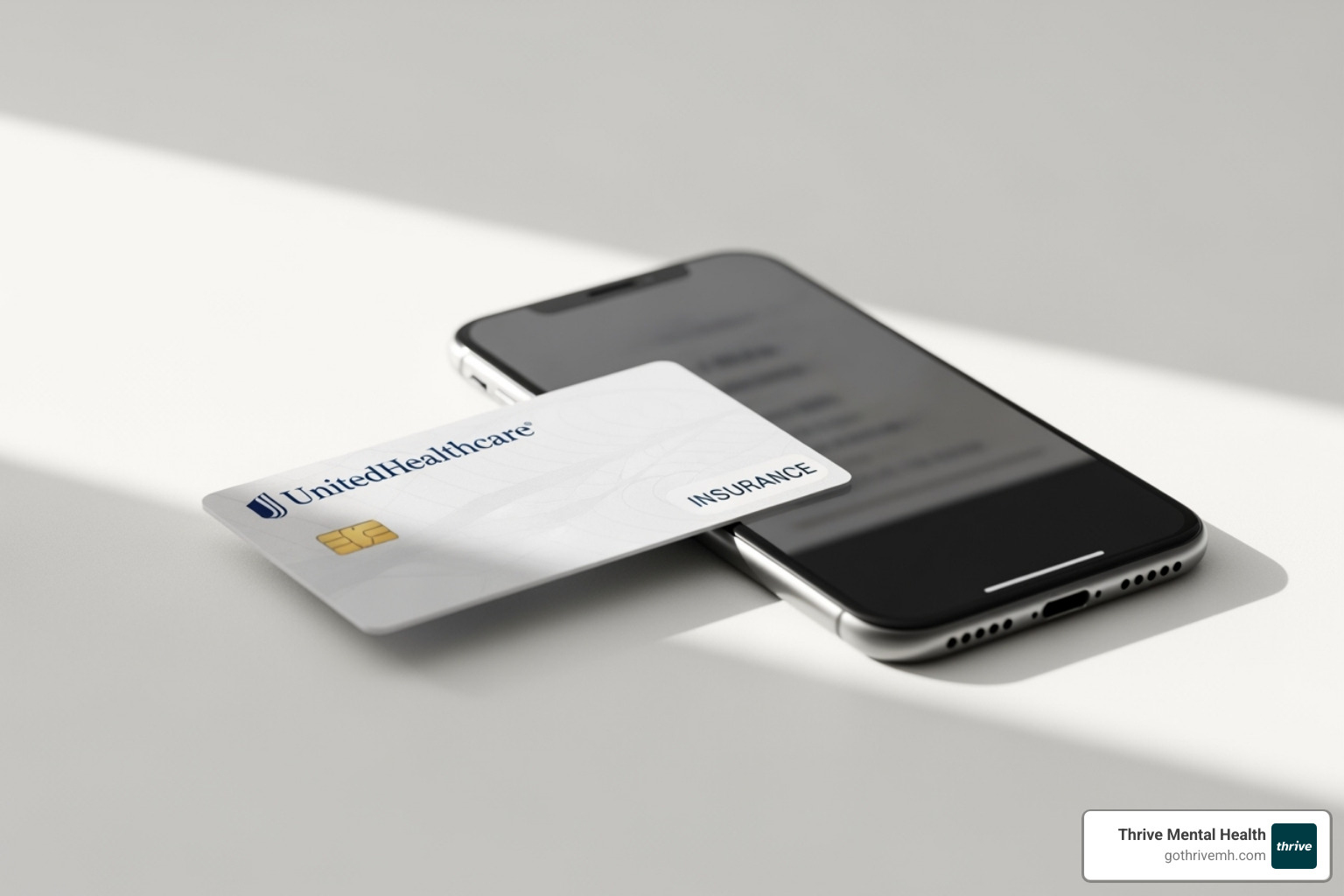 UnitedHealthcare insurance card next to a smartphone - United Healthcare virtual therapy