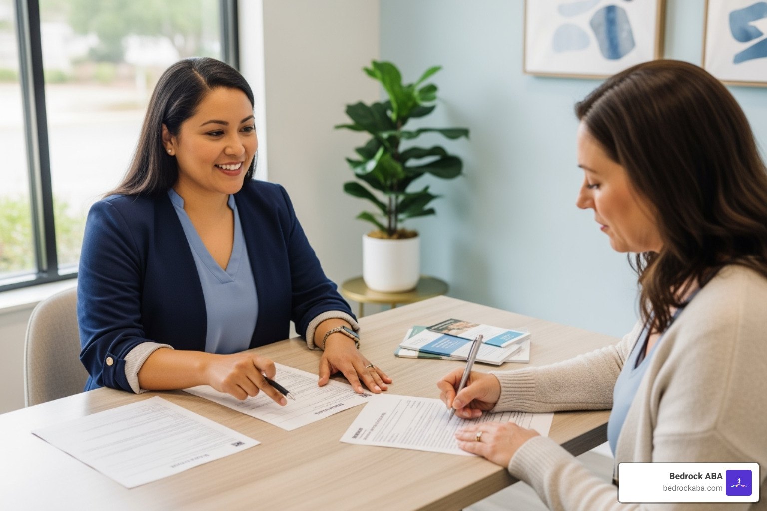 Parent filling out intake forms with staff member - ABA therapy utah