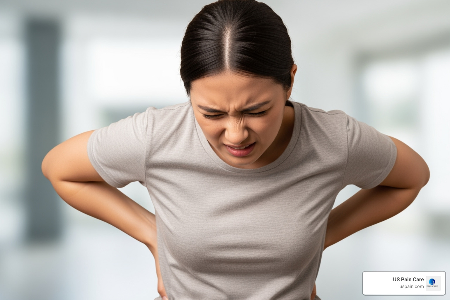 person looking concerned while holding lower back - sciatica treatment carson city