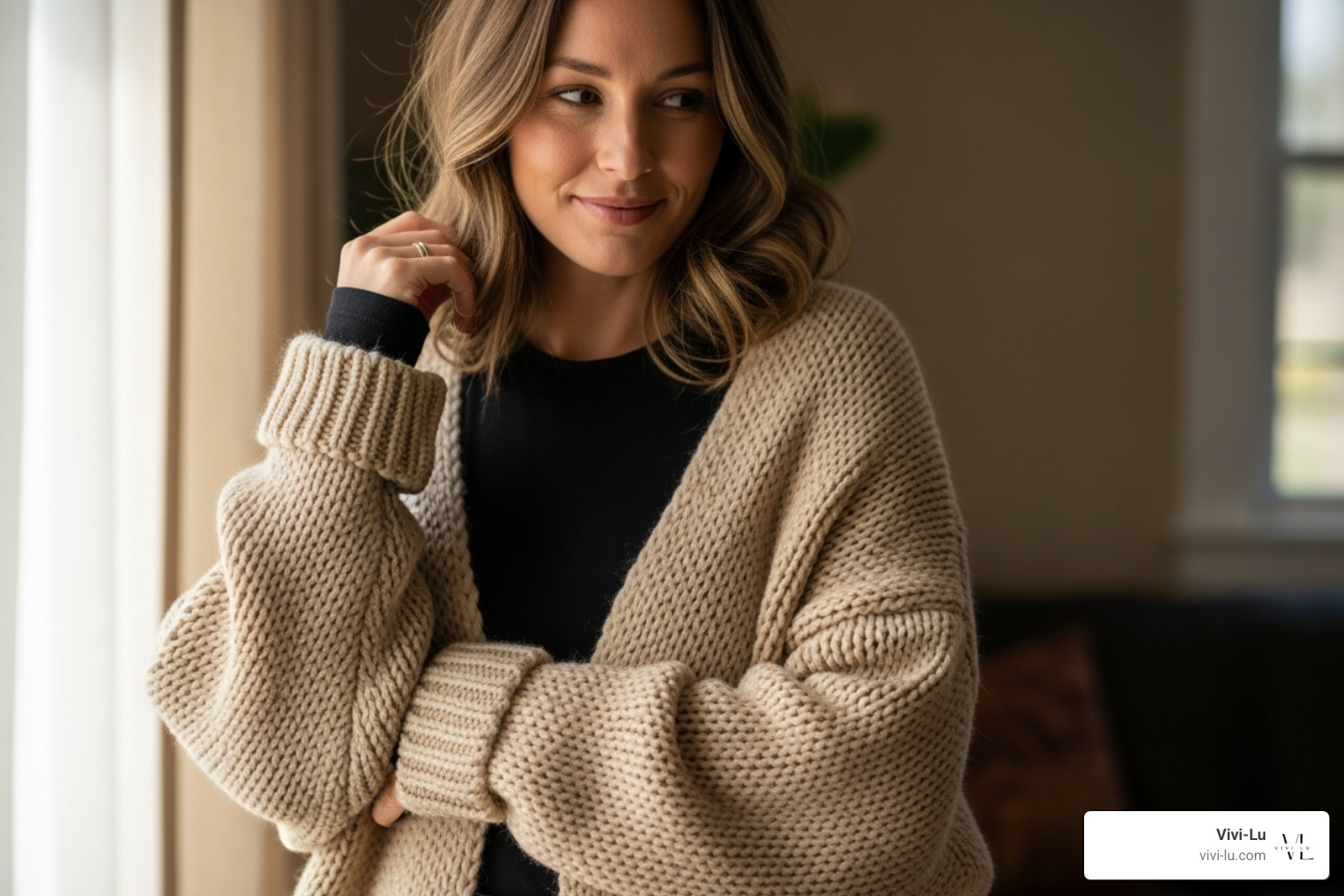 a woman wearing a cozy, oversized cardigan over a simple top - womens autumn clothes