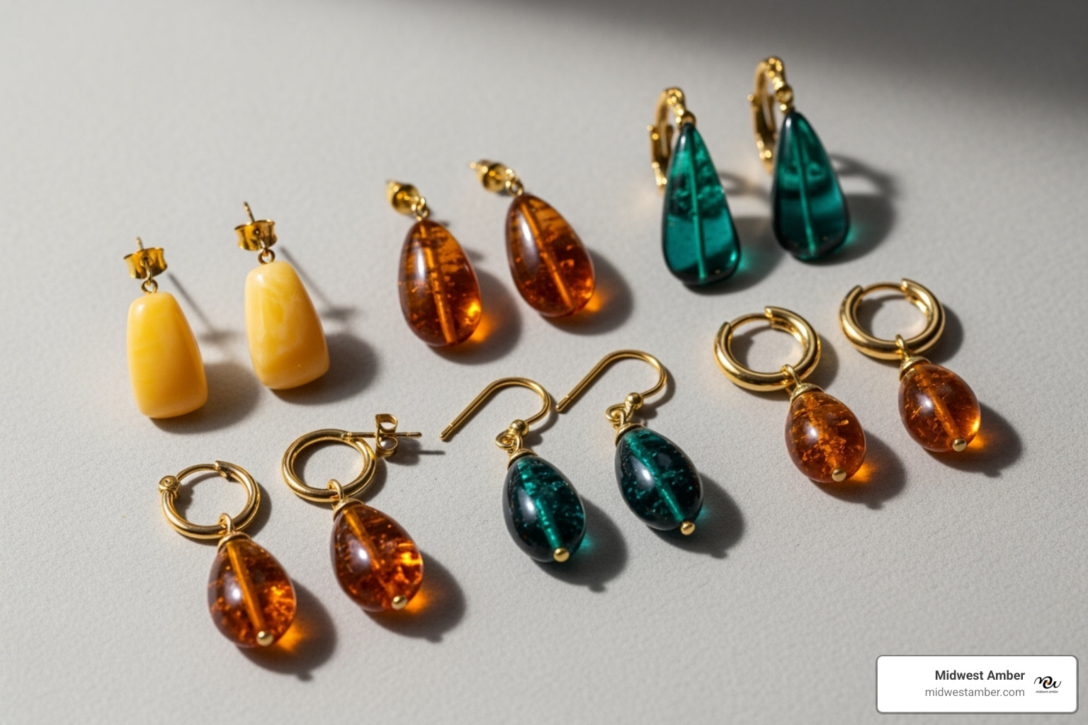 of a flat lay showcasing stud, drop, and hoop amber earrings in various colors - amber earrings