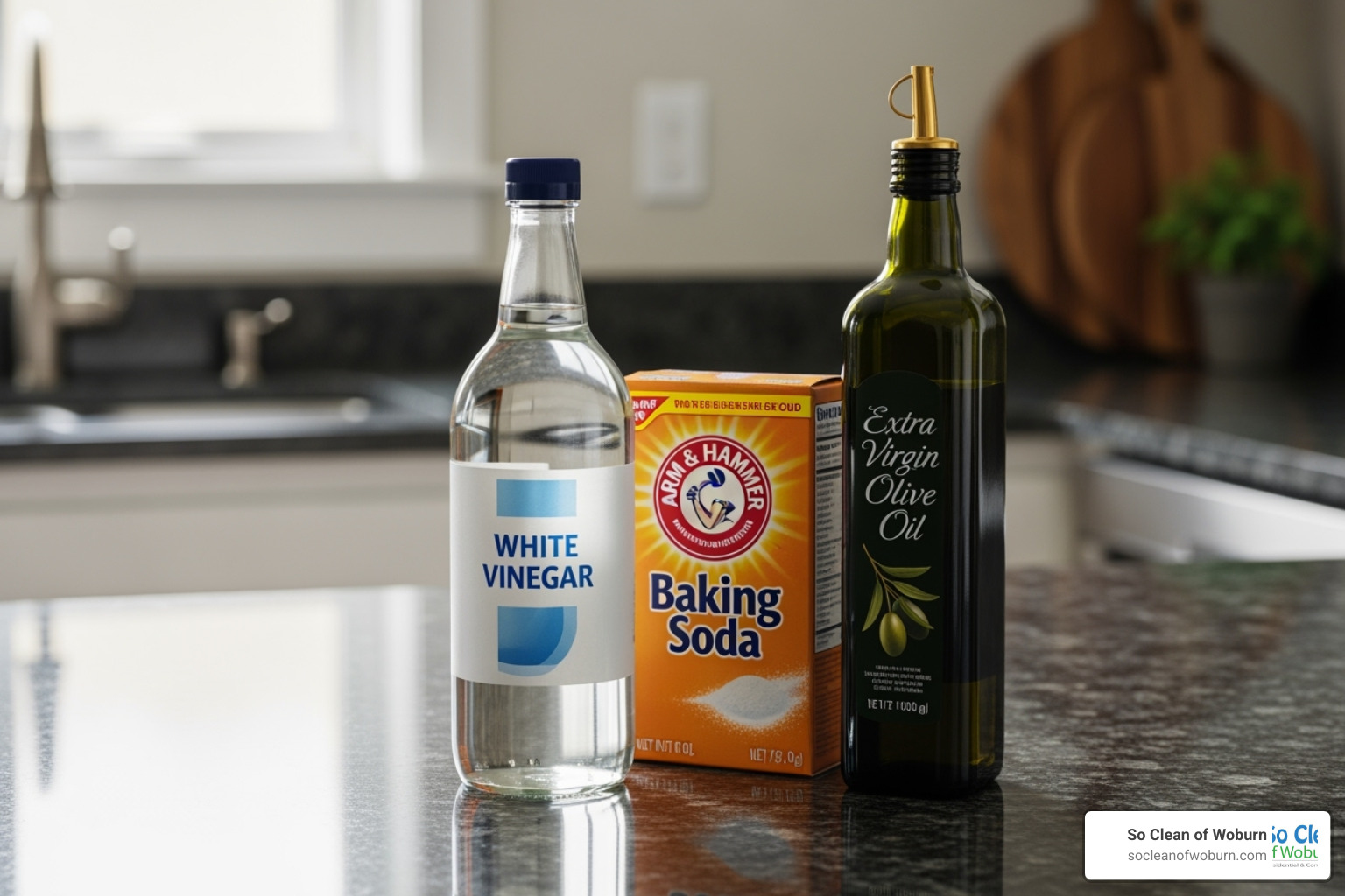 DIY cleaning ingredients like a bottle of vinegar, box of baking soda, and olive oil - natural stainless steel cleaner