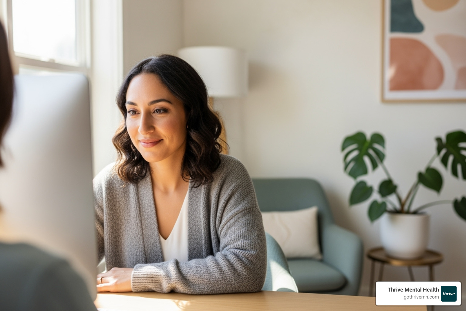 therapist looking warmly at their screen during a session - intensive therapy program online
