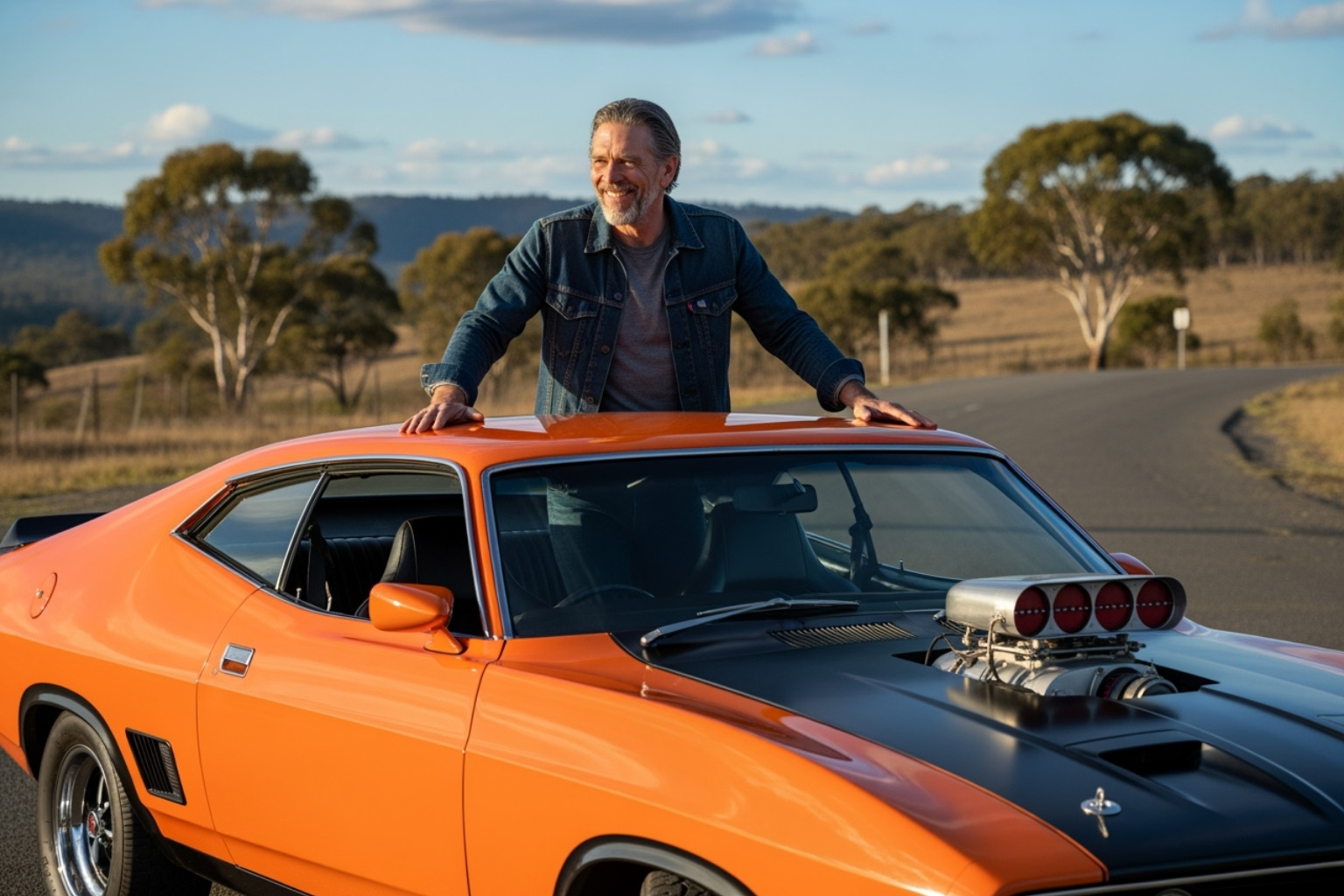 Eric Bana with his iconic 1974 Ford Falcon XB Coupe, smiling beside the classic car - eric bana