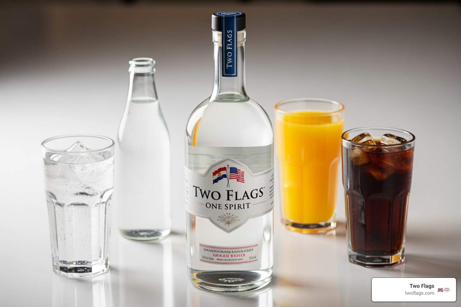 various mixers like soda water, orange juice, and cola next to a bottle of Two Flags One Spirit vodka - does vodka have calories