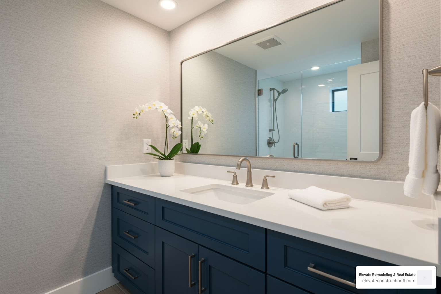 A stylishly updated bathroom with a painted vanity, new brushed nickel hardware, and a framed mirror - home reno