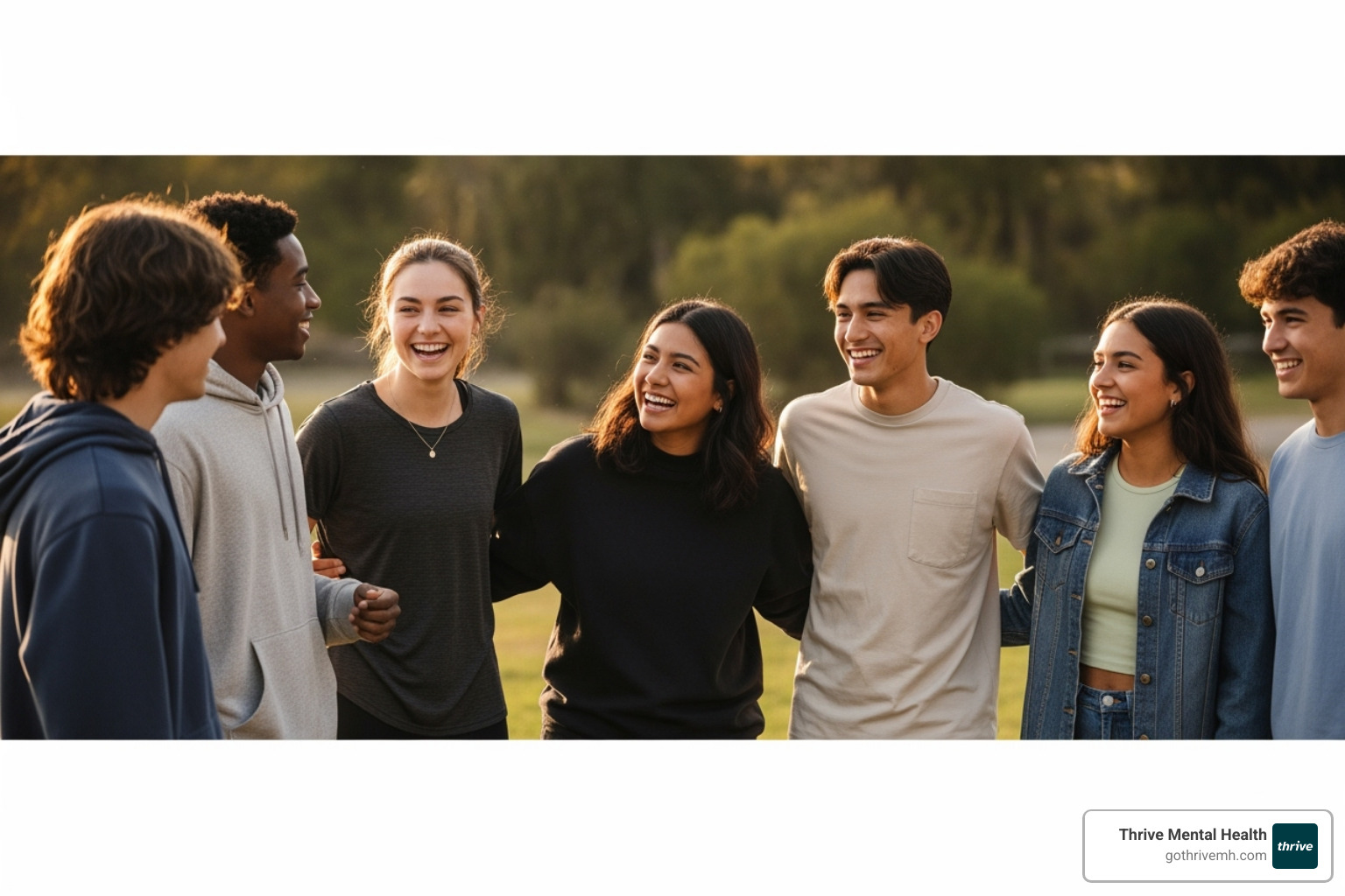 A warm, authentic image of a diverse group of teenagers laughing and talking together outdoors, emphasizing connection and belonging as a key aspect of stress management for teens. - stress management for teens