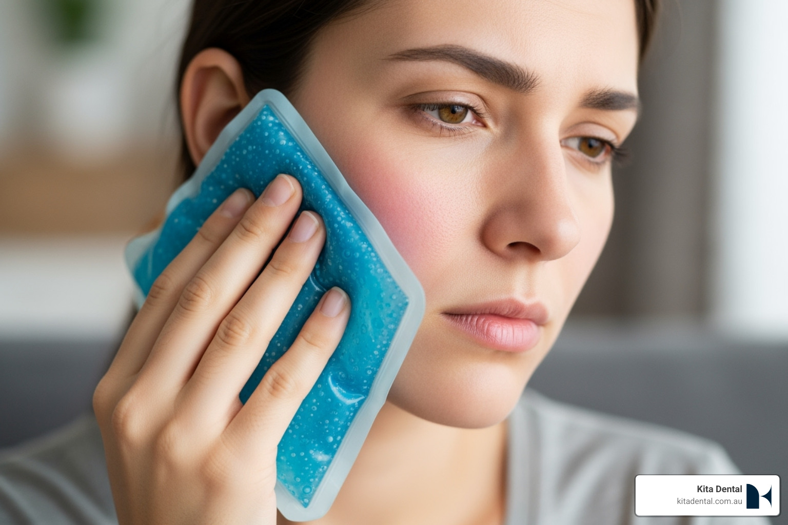 Person applying a cold compress to their cheek - Dental emergency first aid Person applying a cold compress to their cheek - Dental emergency first aid