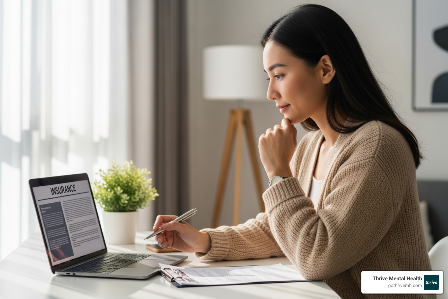 A person sitting at a desk, thoughtfully reviewing insurance documents on a laptop, with a pen in hand. - outpatient psychiatric treatment A person sitting at a desk, thoughtfully reviewing insurance documents on a laptop, with a pen in hand. - outpatient psychiatric treatment
