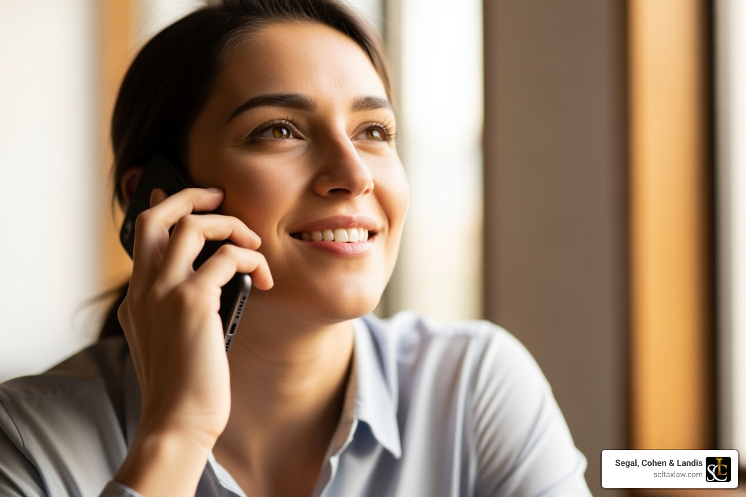 of a person on the phone looking relieved and confident - tax attorney los angeles