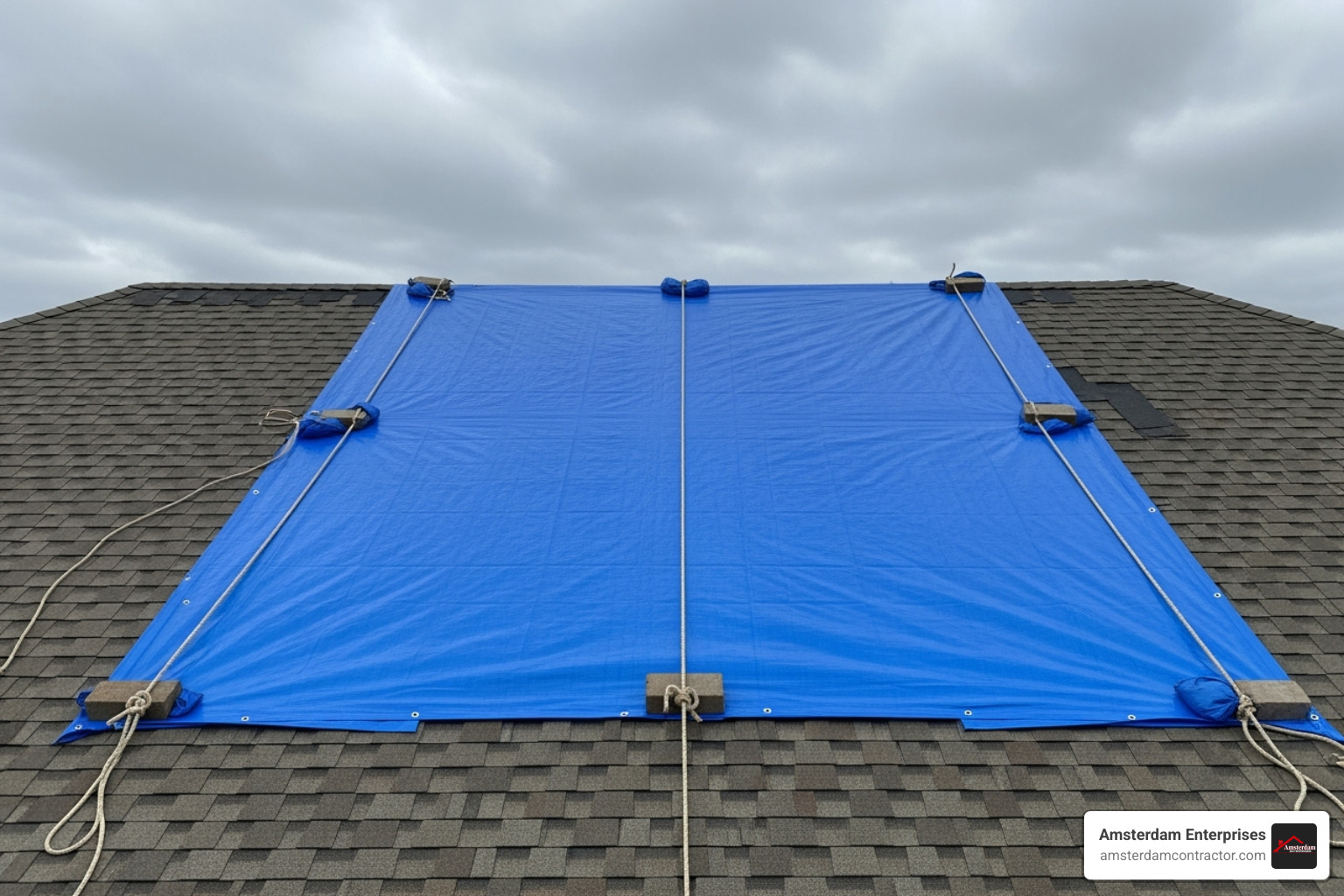 properly secured tarp on section of roof - emergency roof leak fix