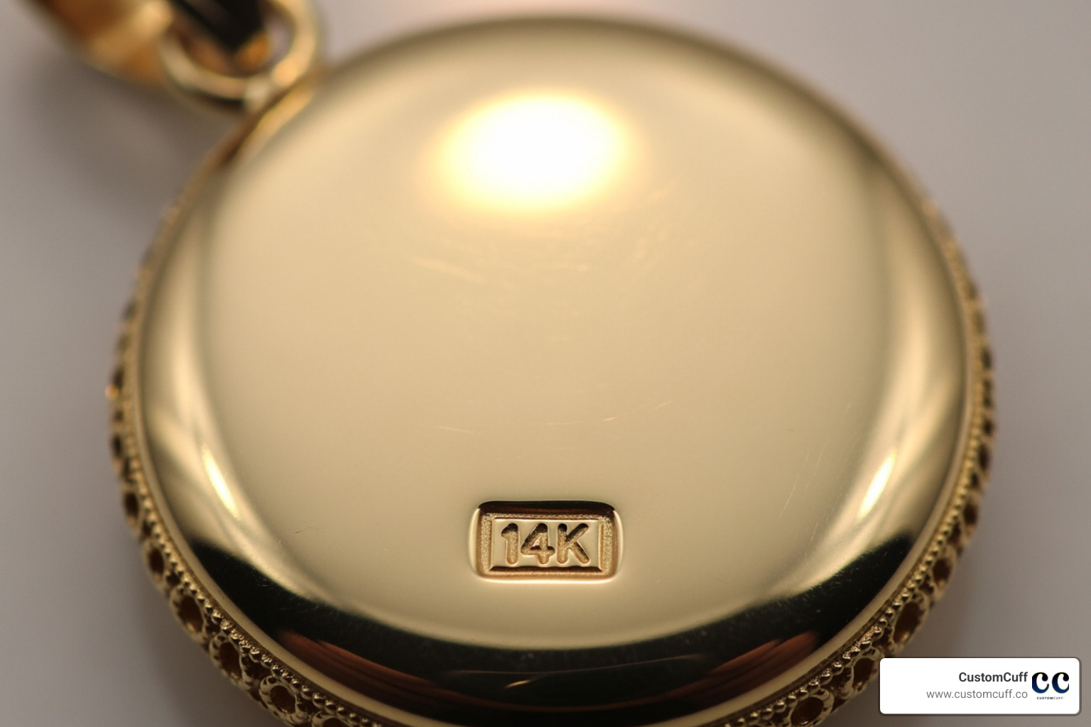 Close-up shot showing the hallmark (e.g., "14K") stamped on a CustomCuff gold pendant. - solid gold gemini pendant