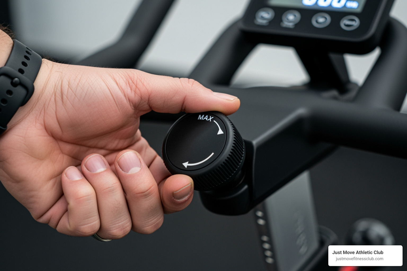 A hand turning the resistance knob on a spin bike - spin class experience