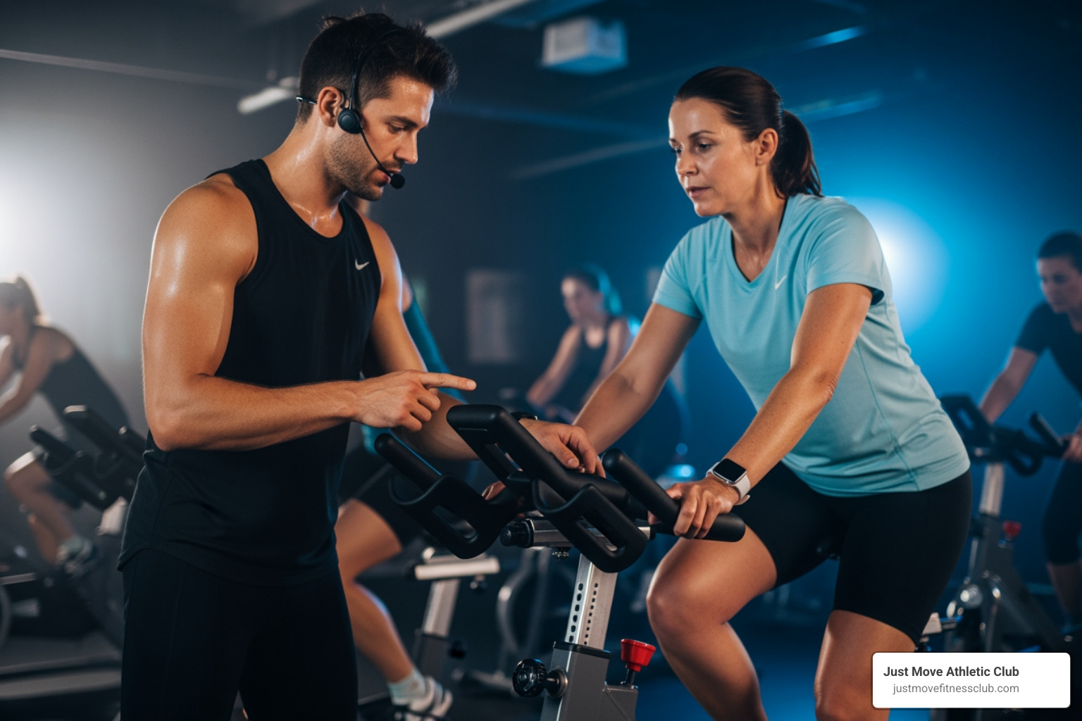 An instructor helping a beginner adjust their spin bike seat - spin class experience