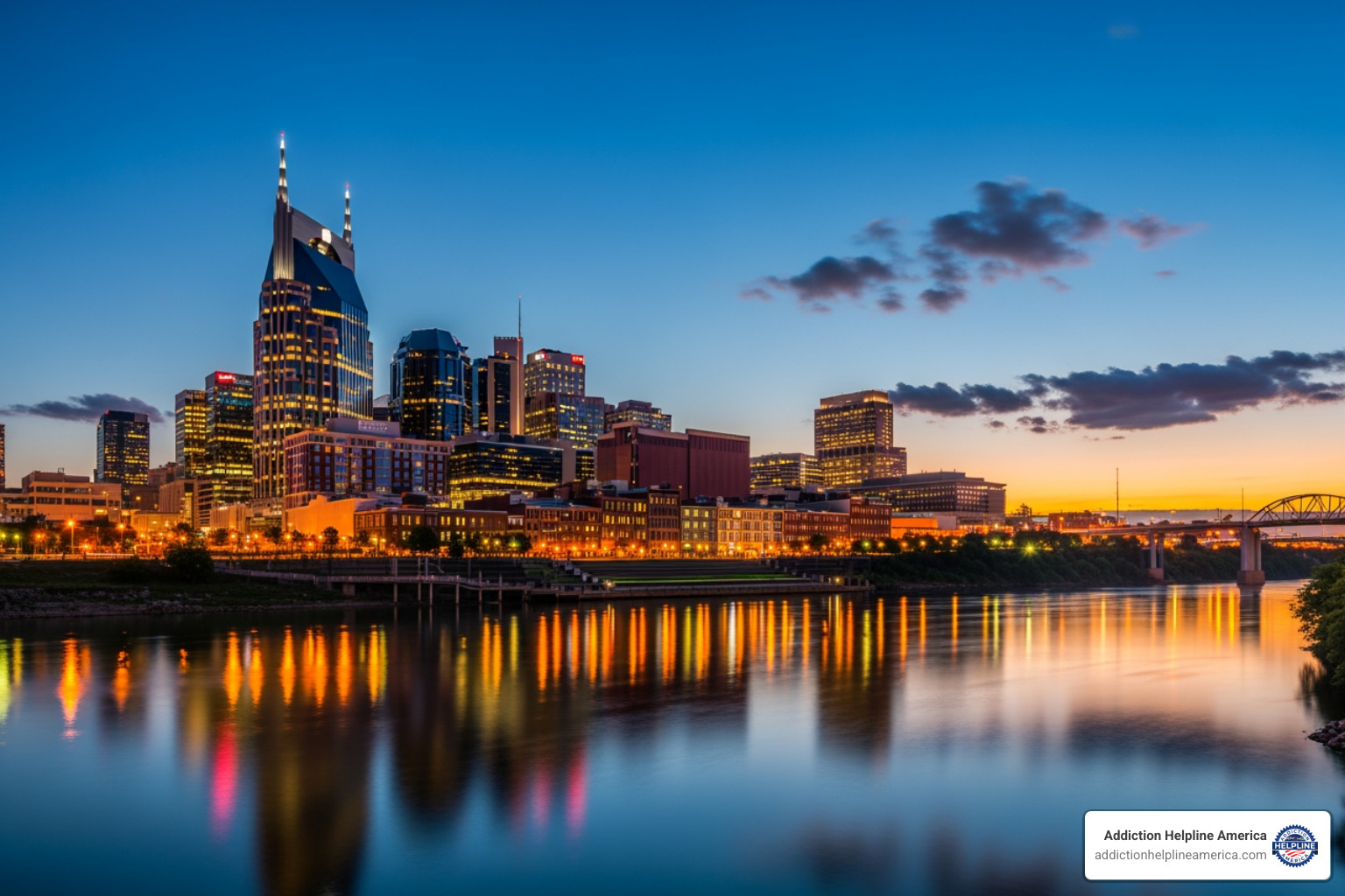 Nashville skyline at dusk with city lights reflecting on the Cumberland River. - sober living Nashville Nashville skyline at dusk with city lights reflecting on the Cumberland River. - sober living Nashville