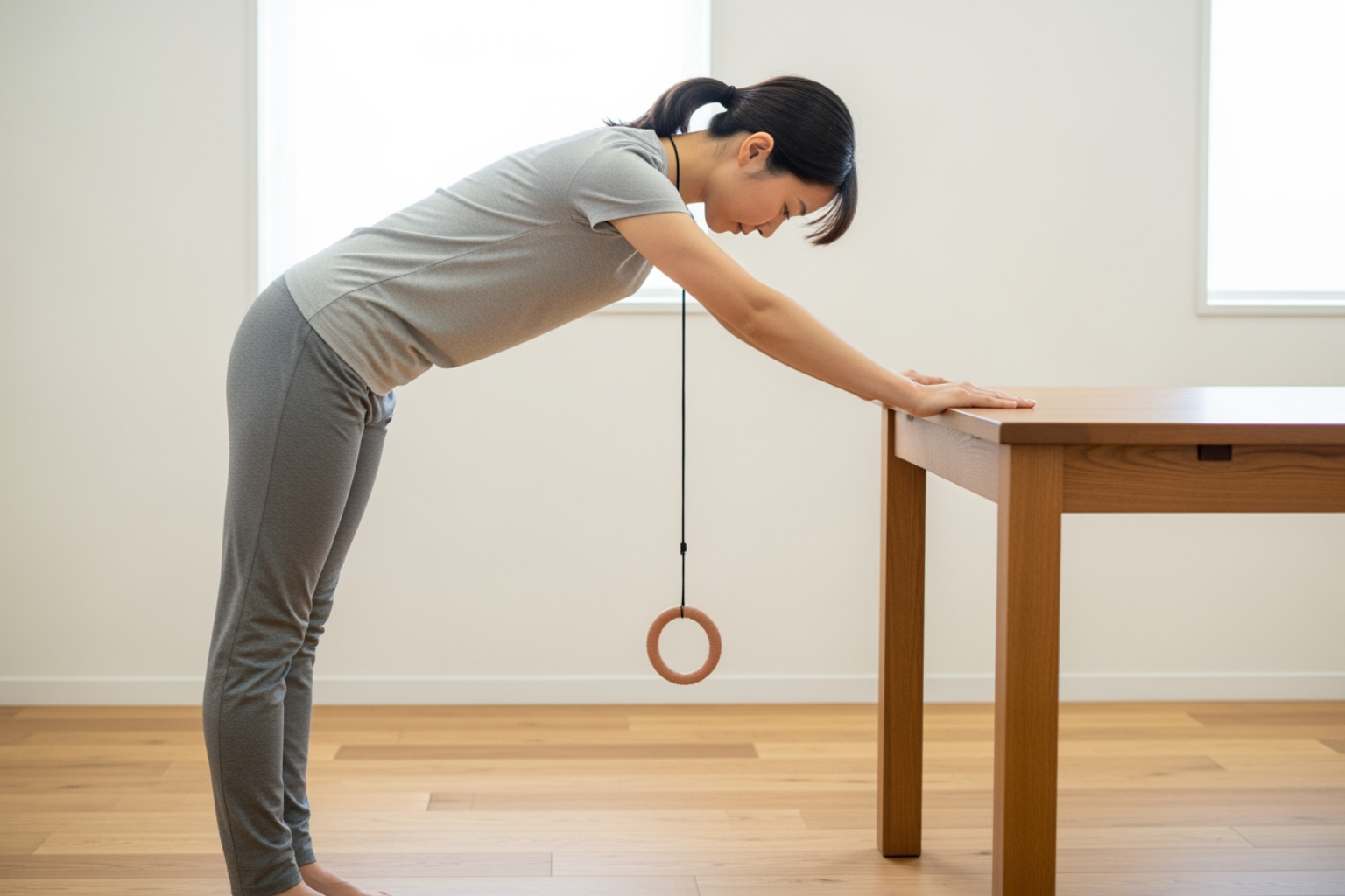 person doing a pendulum stretch - shoulder recovery workout
