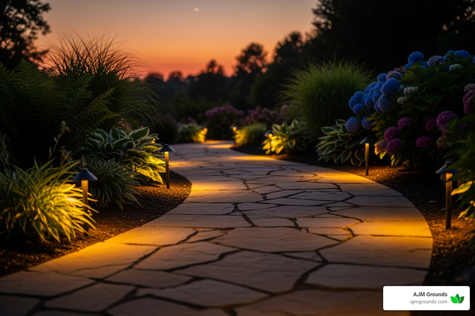 Curved stone path with low-voltage lights along the edge, illuminating it at dusk - Backyard stone pathways