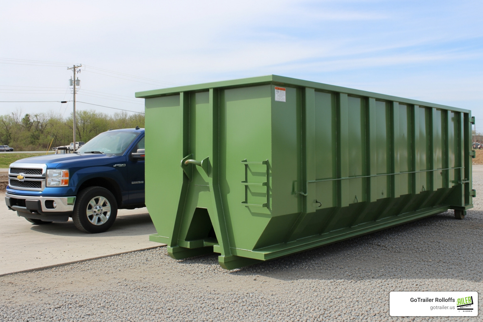 A 15-yard dumpster next to a standard pickup truck for size comparison - 15 yard roll off