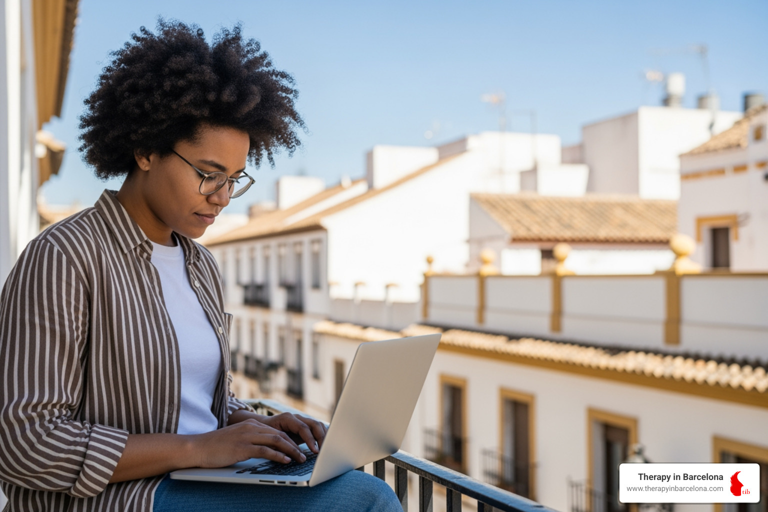 person working on laptop on sunny Spanish balcony - work in spain for english speakers