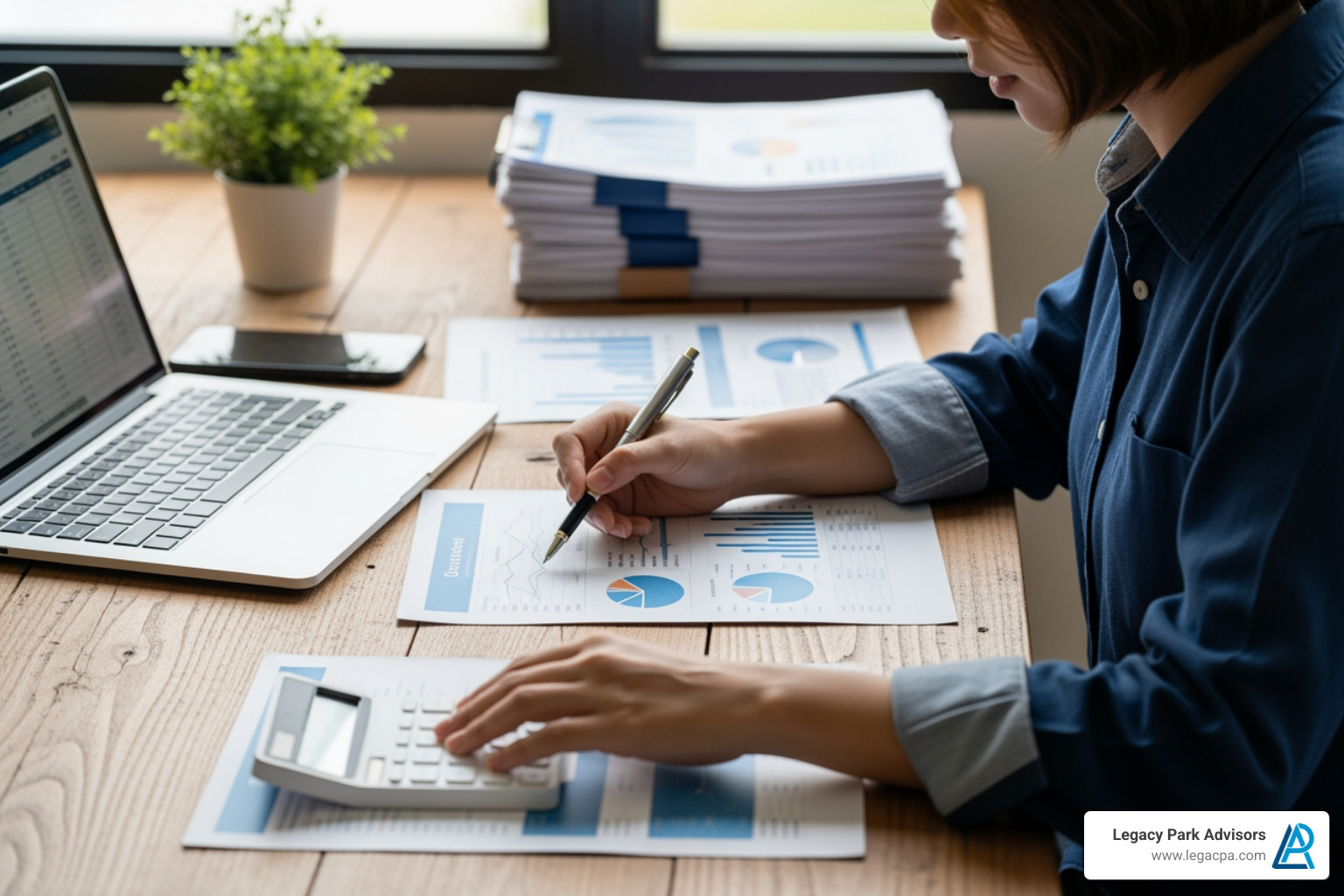 person working on financial documents with a calculator and laptop - tax advisor san diego person working on financial documents with a calculator and laptop - tax advisor san diego