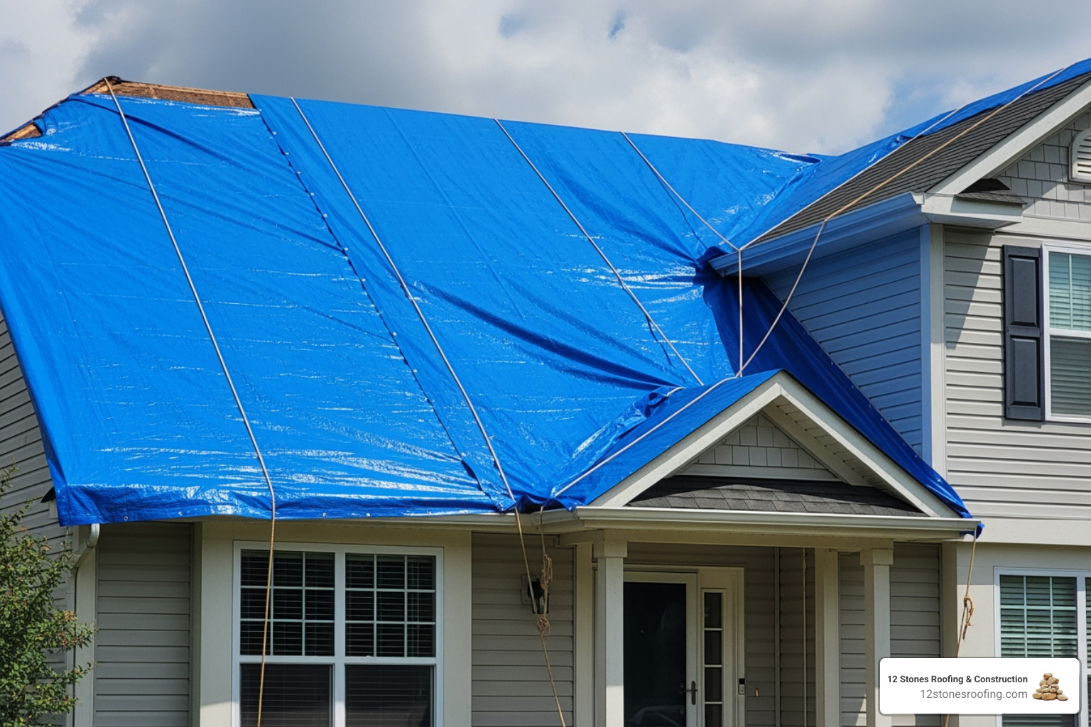 blue tarp temporarily covering a damaged section of roof - roof leakage repair near me