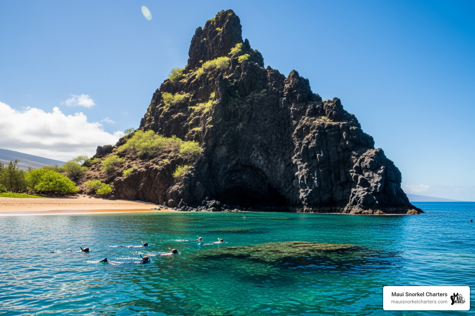 Black Rock with snorkelers in the water nearby - best snorkeling beaches in maui for beginners