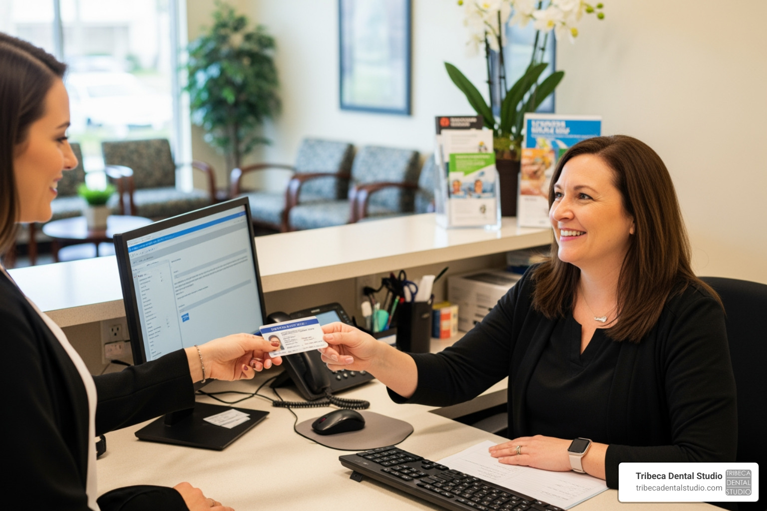 A patient handing their insurance card and ID to a friendly receptionist at a dental office. - emergency dentist nyc medicaid