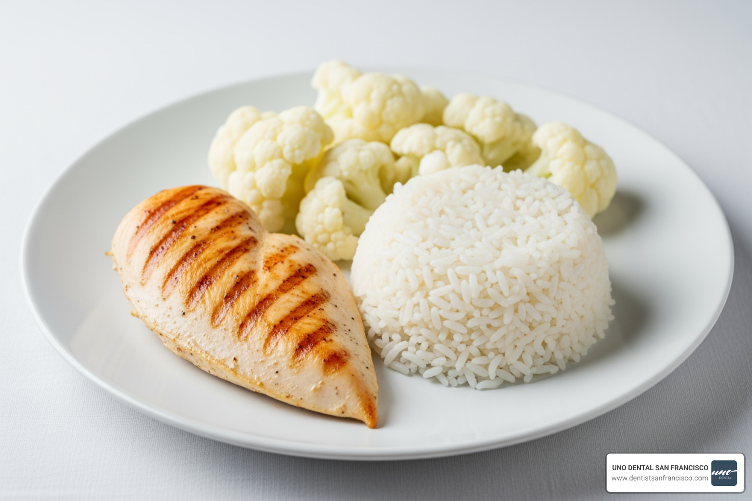 A plate with grilled chicken, cauliflower, and white rice representing a "white diet" - professional teeth whitening aftercare A plate with grilled chicken, cauliflower, and white rice representing a "white diet" - professional teeth whitening aftercare