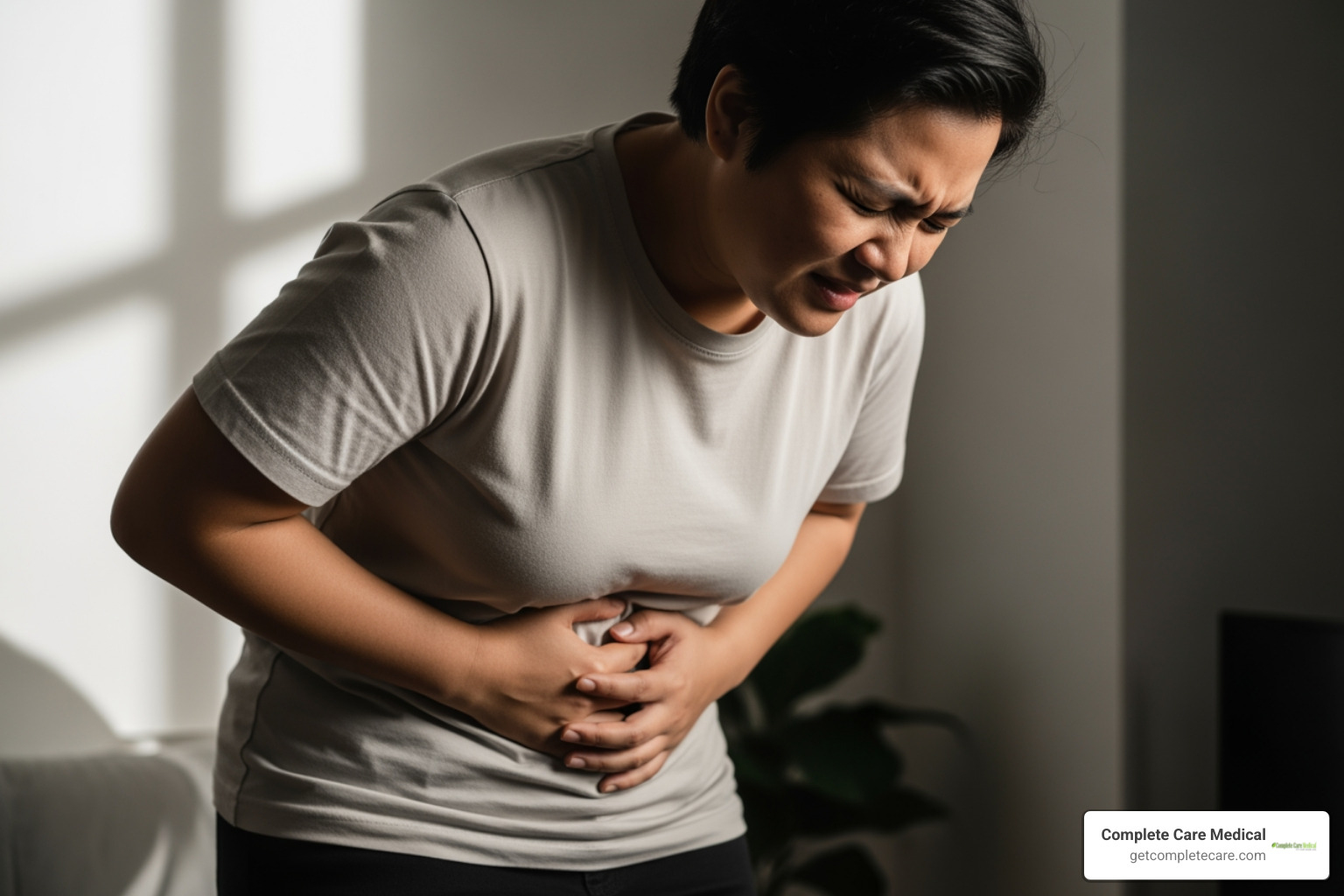 person holding lower abdomen in discomfort - burning with urination