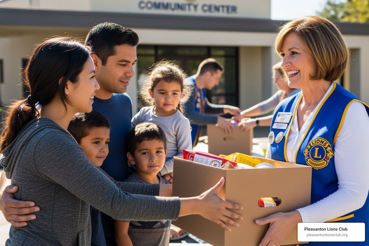 A Pleasanton Lions Club volunteer hands a box of food to a family - Donate to community