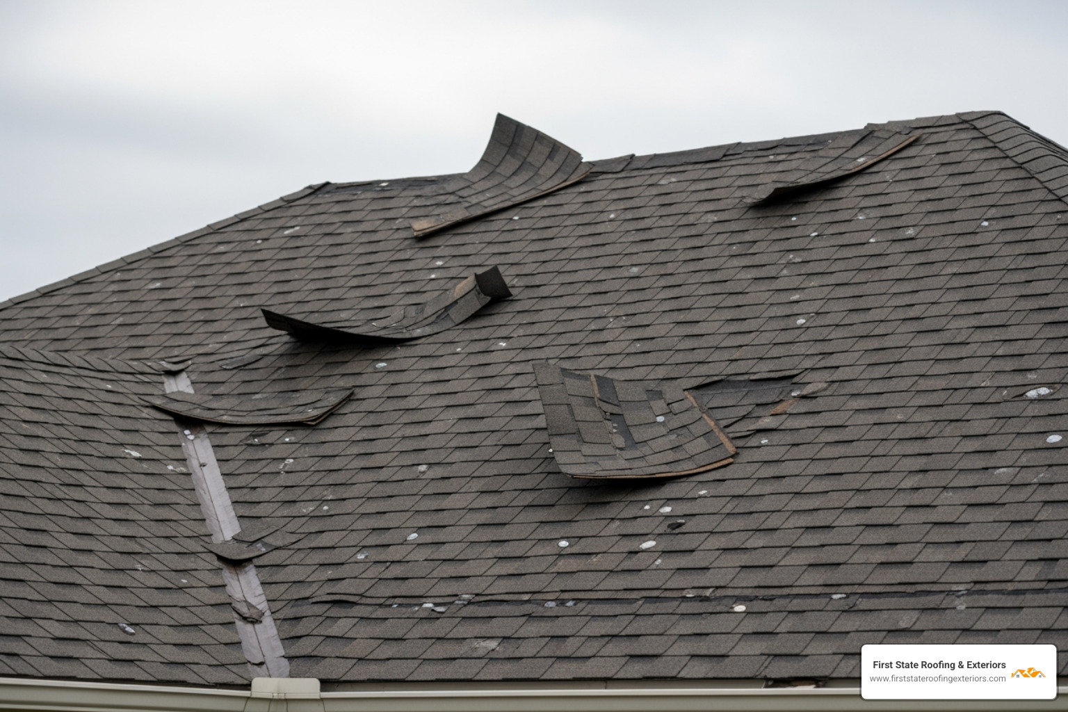 Storm-damaged shingles on a residential home in Sussex County showing wind uplift and hail impact - Sussex County roofing