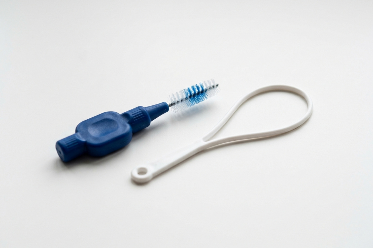 Interdental brush and floss threader for cleaning braces.