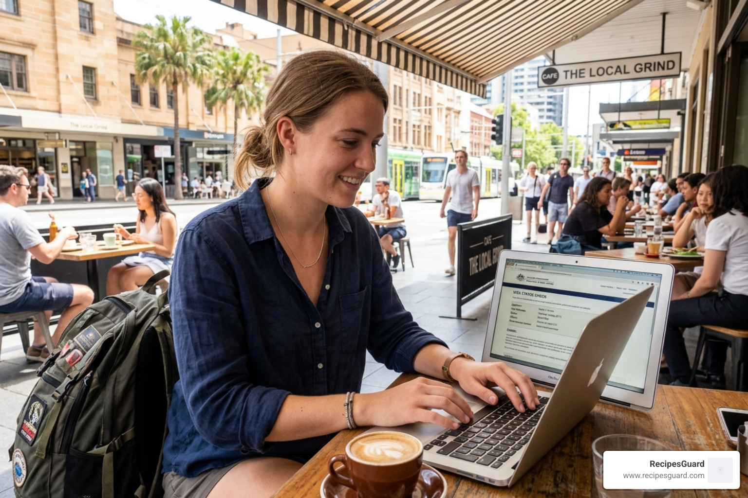 Backpacker checking their visa status on a laptop while sitting at a cafe - australia backpacker claim filing guide