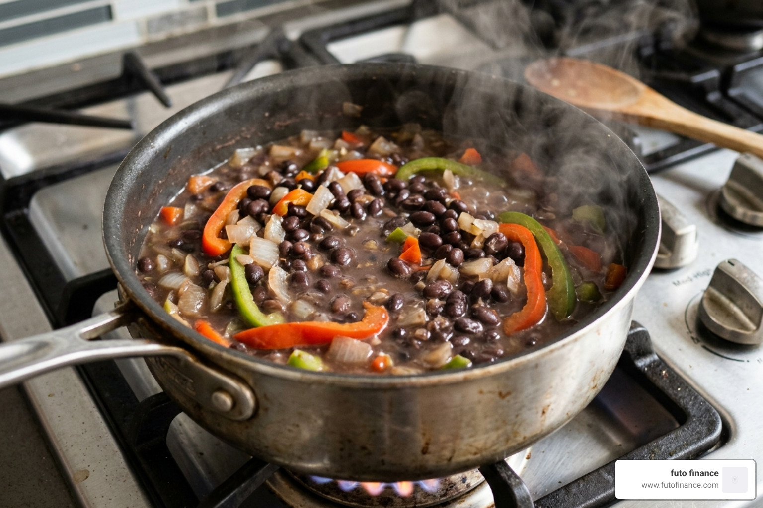 beans simmering in a stainless steel pot with onions and peppers - easy black bean vegan