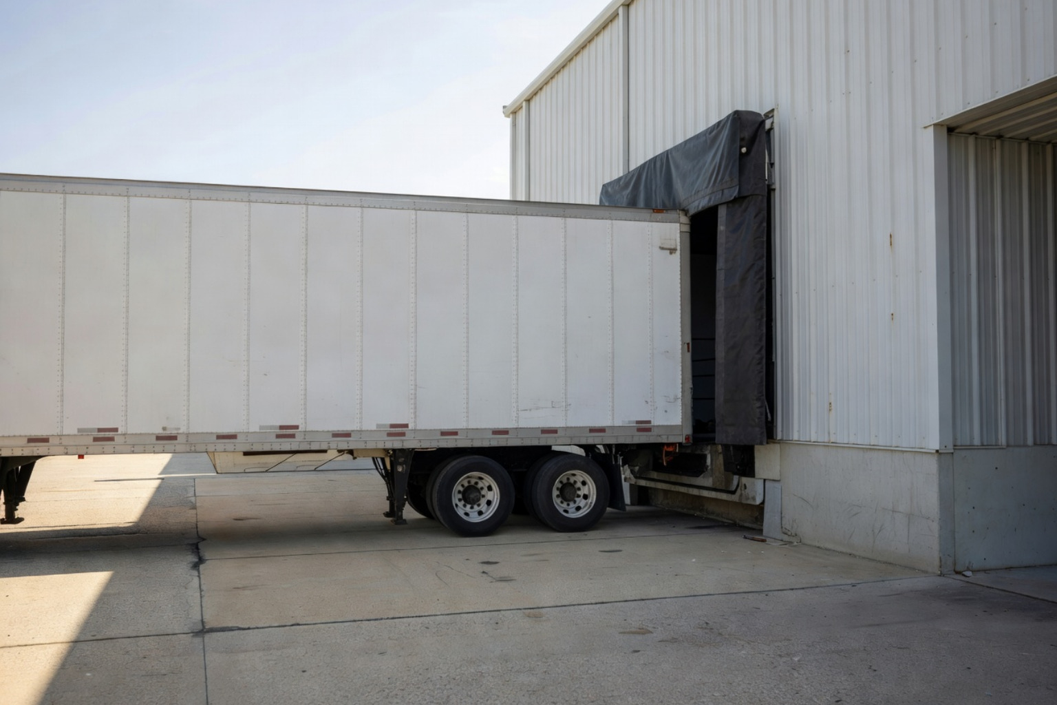 refrigerated loading dock with a truck trailer attached and a tight weather seal - cold storage facility