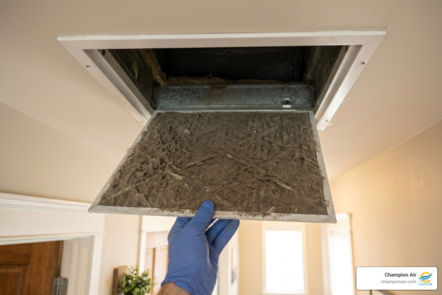 A close-up of a heavily dust-clogged HVAC air filter being removed from a home ceiling vent - how to choose the right ac