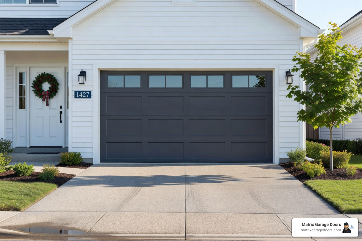Technician lubricating garage door rollers - benefits of preventative maintenance garage doors