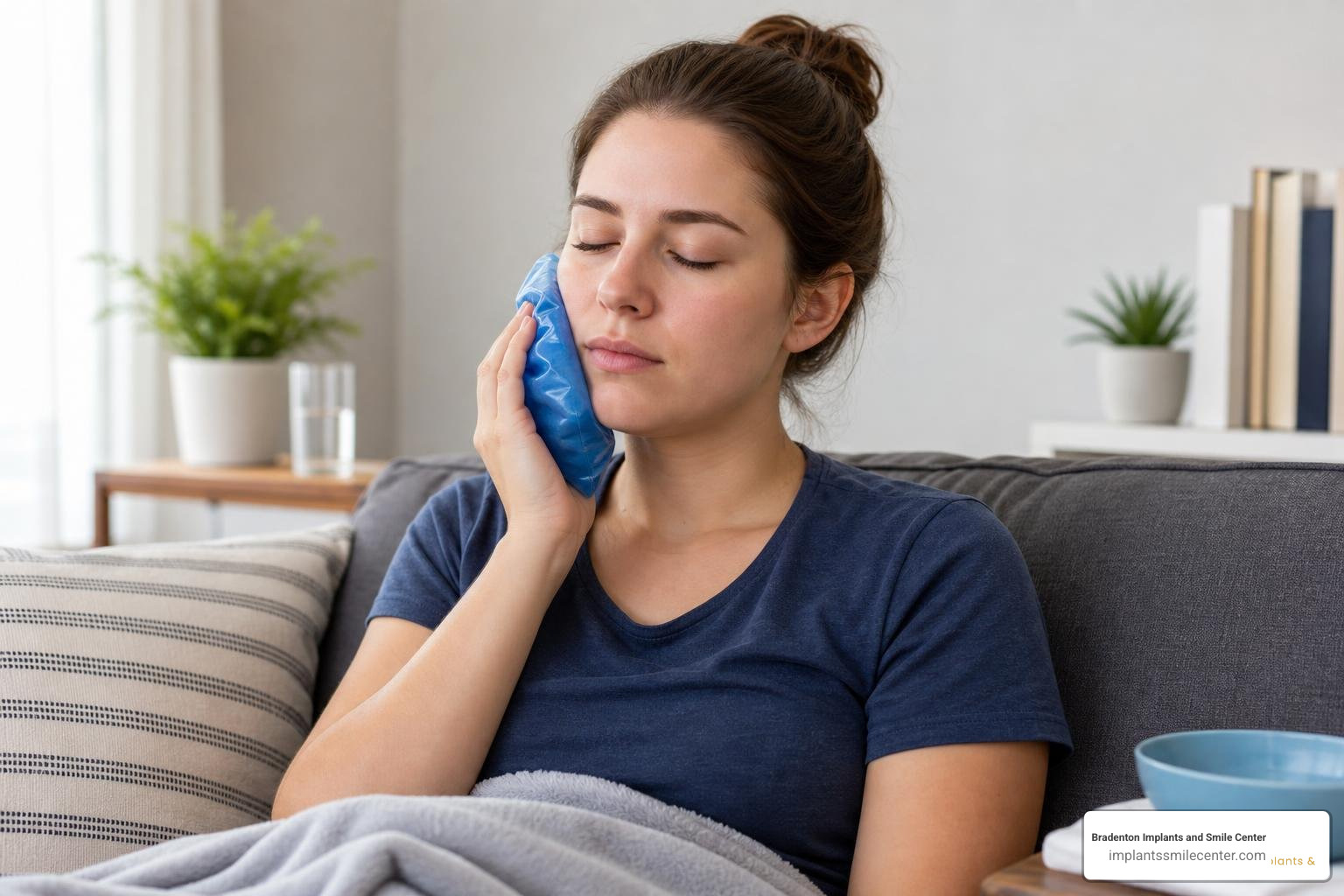 Applying a cold compress to the cheek to reduce swelling after tooth extraction
