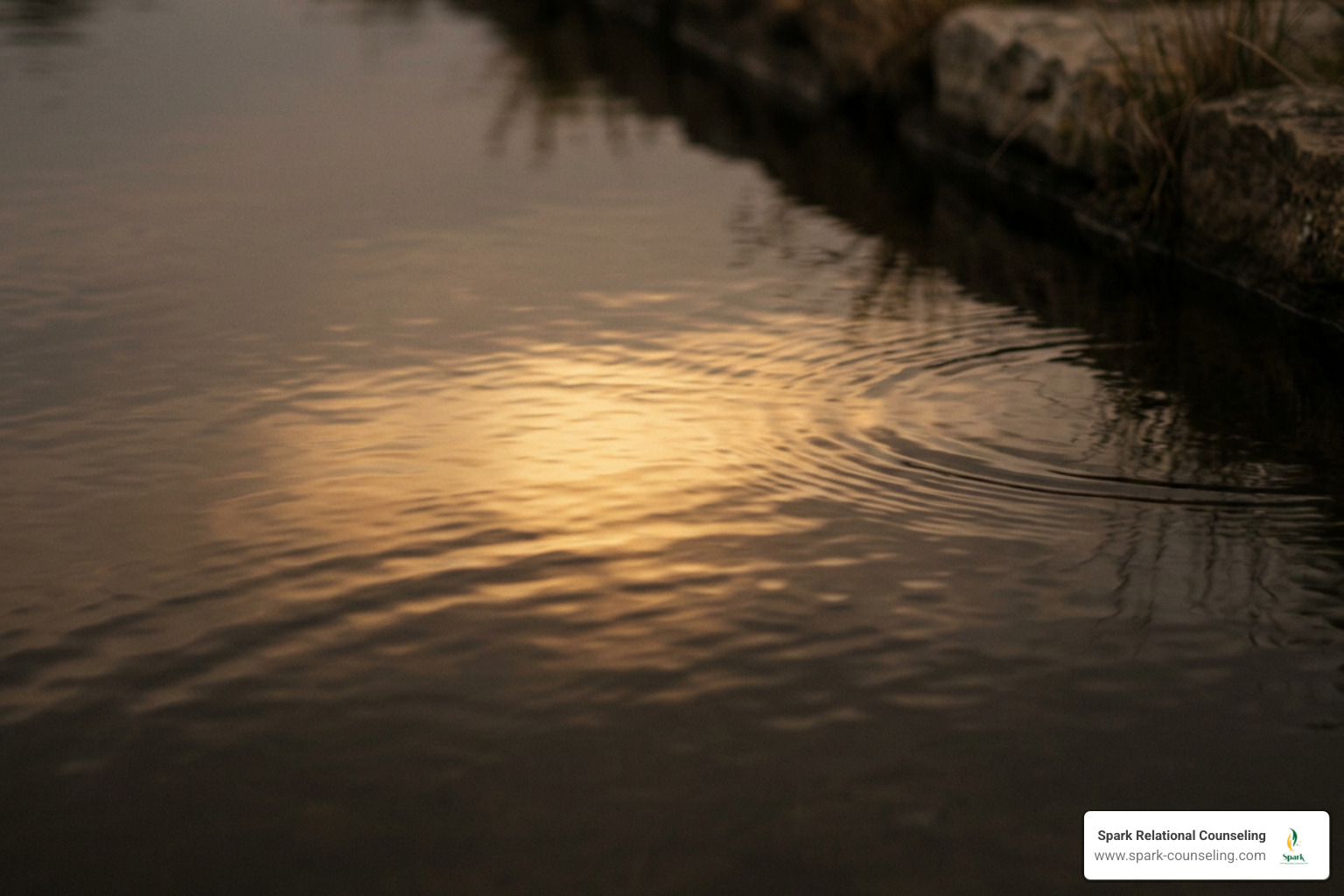 Soft warm yellow light reflecting on calm water surface representing self-regulation