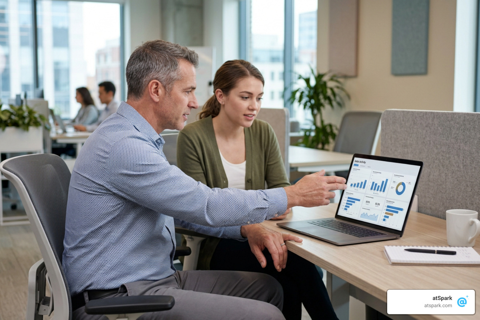 Sales manager coaching a sales representative using a clean, visual activity dashboard