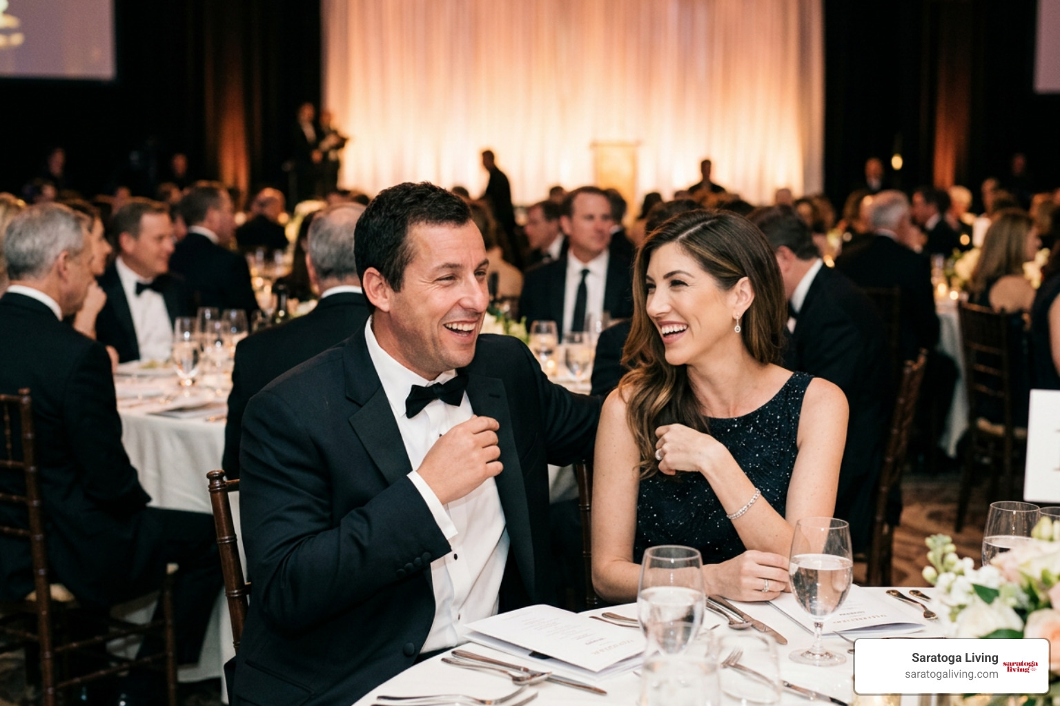 Adam and Jackie Sandler laughing together at an awards ceremony Adam and Jackie Sandler laughing together at an awards ceremony