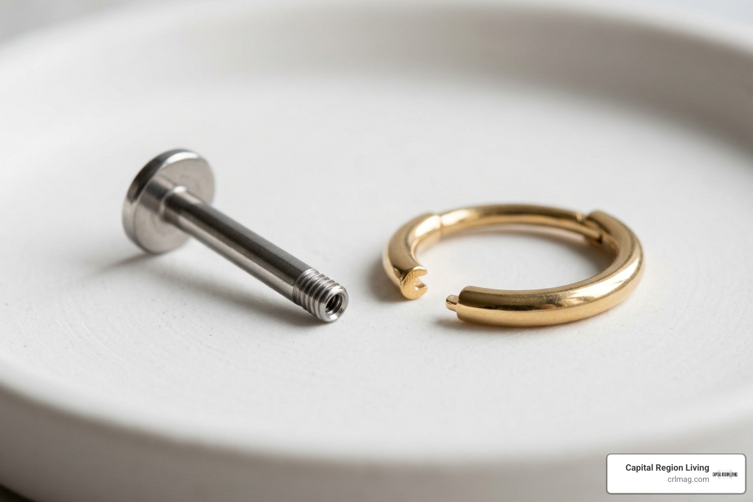Close up of internally threaded titanium flat back labret studs and gold clickers Close up of internally threaded titanium flat back labret studs and gold clickers