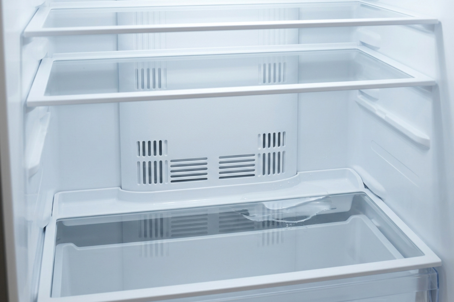 refrigerator interior airflow vents and drainage trough