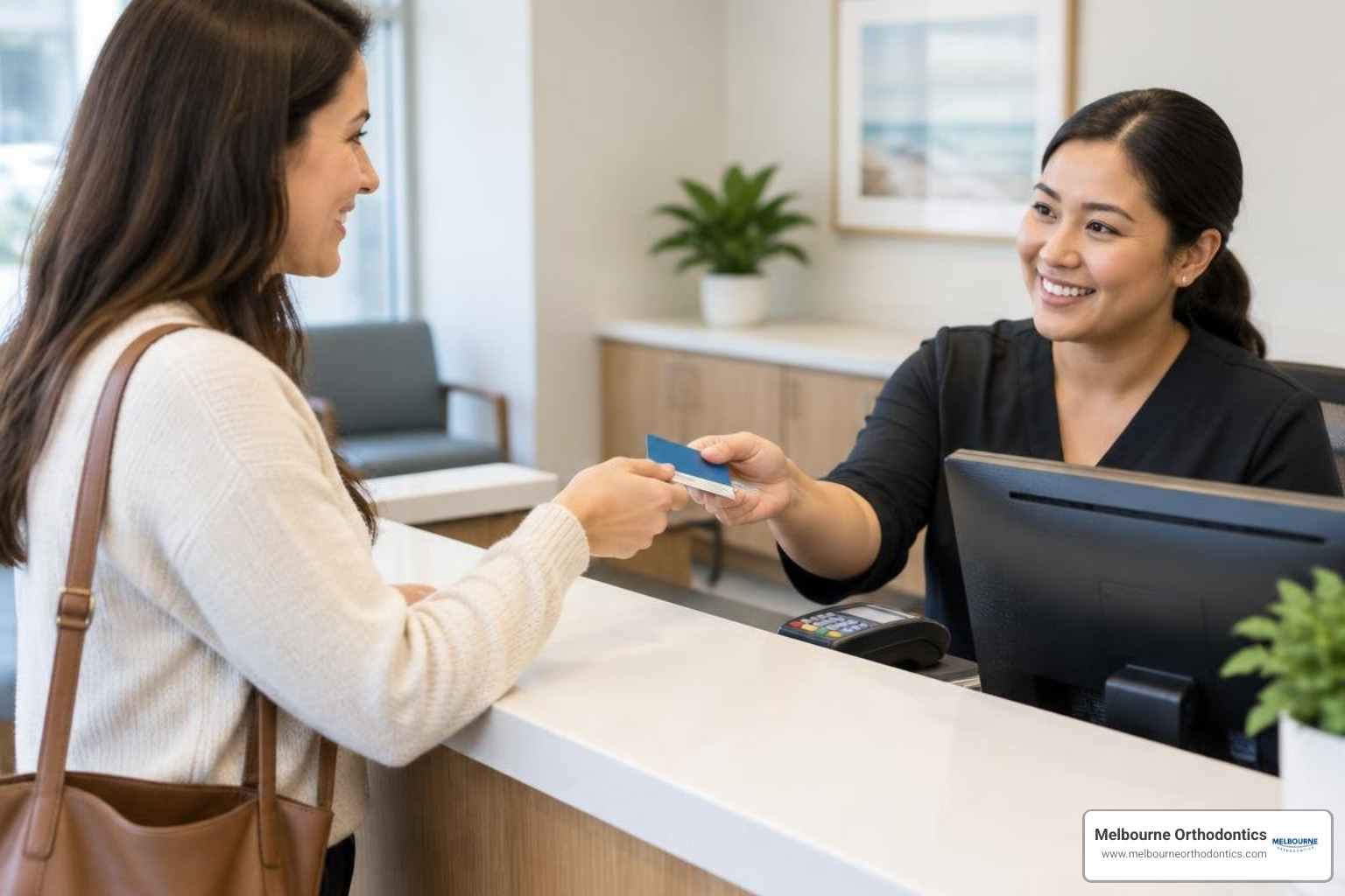 patient using health savings cards at a dental reception desk patient using health savings cards at a dental reception desk